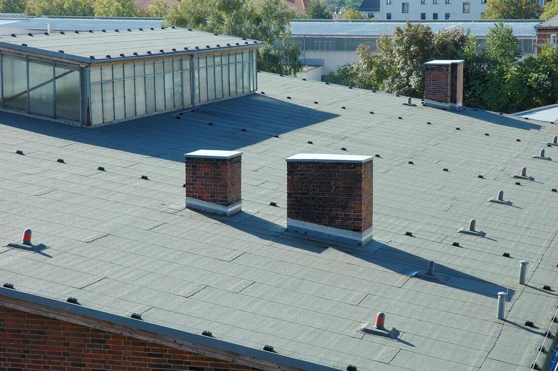 Low-slope roof surface being inspected